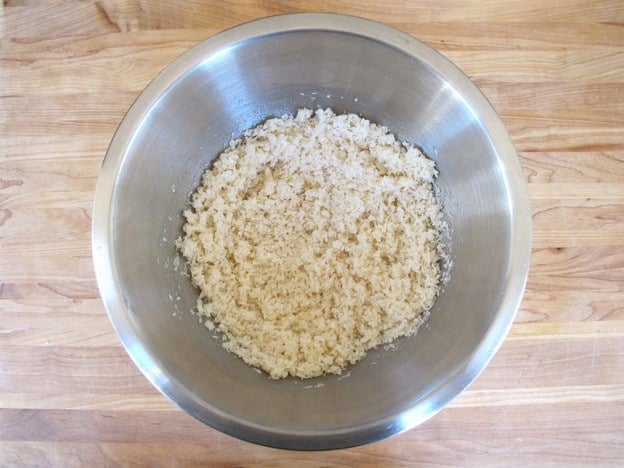 Egg whites stirred into shredded coconut.