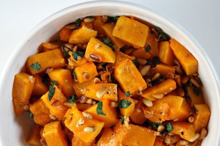 Roasted Butternut Squash with Sage and Pine Nuts - Kosher for Passover roasted butternut squash tossed with sauteed garlic, sage and pine nuts. The perfect side dish for your Passover seder from Lori Lange of RecipeGirl.