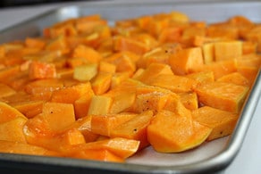Roasted, diced butternut squash on a baking sheet.