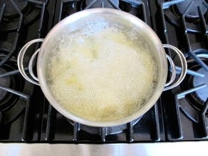 Potatoes boiling in a stockpot.