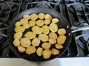 Frying potatoes in a skillet.