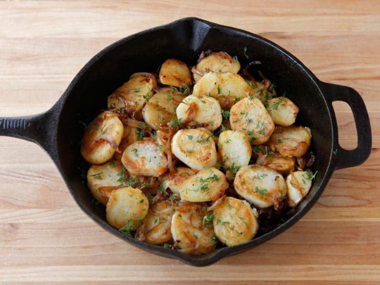 Schmaltz Potatoes Lyonnaise - A classic French potato dish with a Yiddish twist. Potatoes Lyonnaise made with schmaltz, caramelized onions and fresh dill. Kosher for Passover.