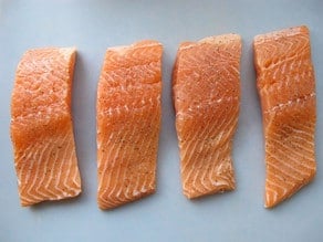 Salmon fillets on a cutting board.