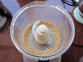 Toasted almonds in a food processor.