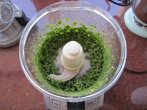 Basil leaves in the food processor.
