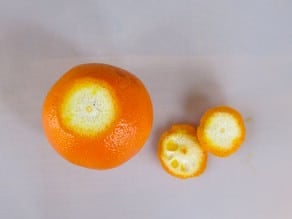 Peel ends sliced off an orange.