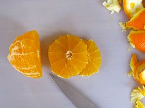Slicing an orange into rounds.