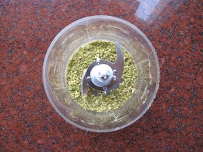 Chopping pistachios in a food processor.