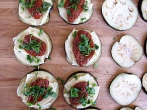 Sundried tomatoes on top of eggplant rounds.