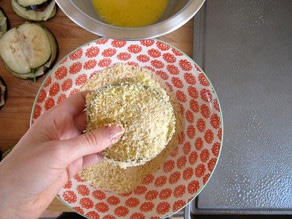 Dipping an eggplant sandwich in panko.