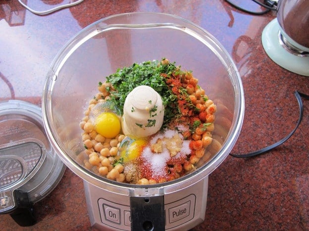 Chickpeas, eggs, seasonings in the food processor.