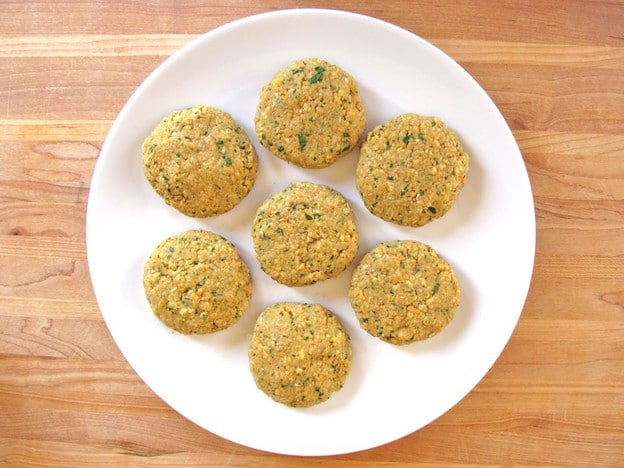 Formed chickpea patties on a plate.