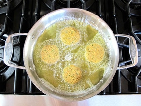Frying chickpea patties in a skillet.