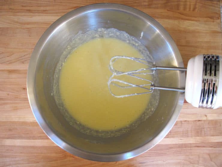 Butter, sugar, and ricotta creamed in a mixing bowl.