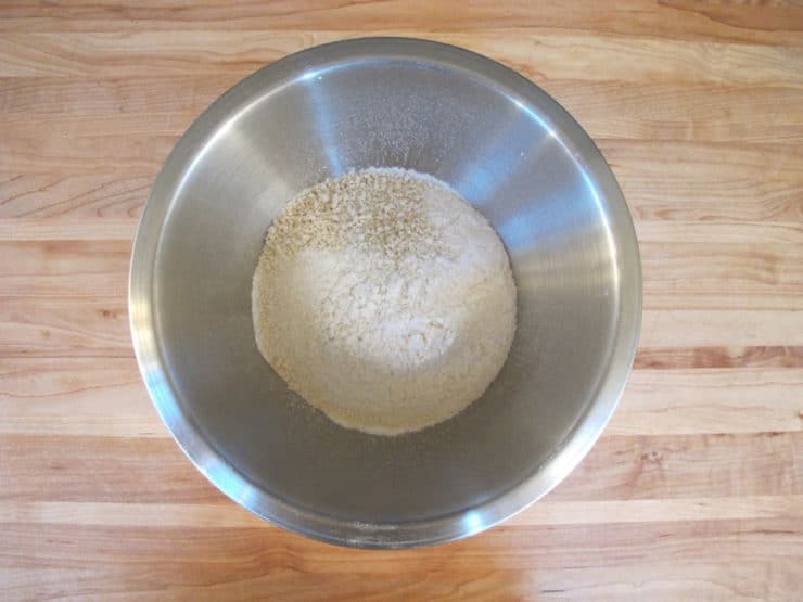 Dry cake ingredients sifted into a mixing bowl.