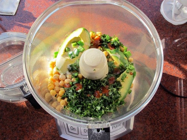 Chickpeas and other ingredients in a food processor.