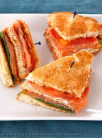 Smoked Salmon Club Sandwich - A simple and delicious club sandwich with smoked salmon, capers, cream cheese spread, lettuce and tomato. Kosher.