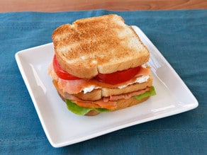 Smoked Salmon Club Sandwich - A simple and delicious club sandwich with smoked salmon, capers, cream cheese spread, lettuce and tomato. Kosher.