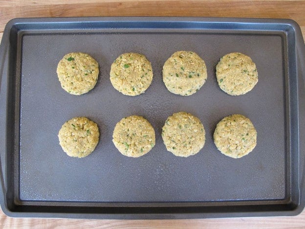 Chickpea patties on a baking sheet.