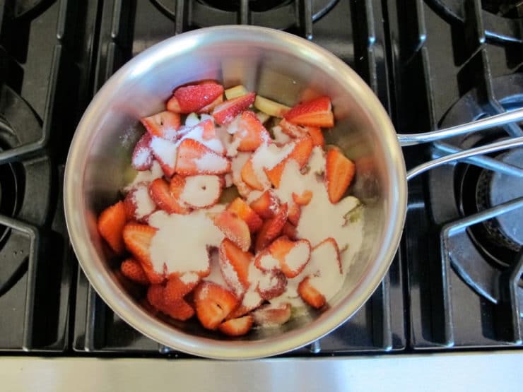 Sugared strawberries in a saucepan.