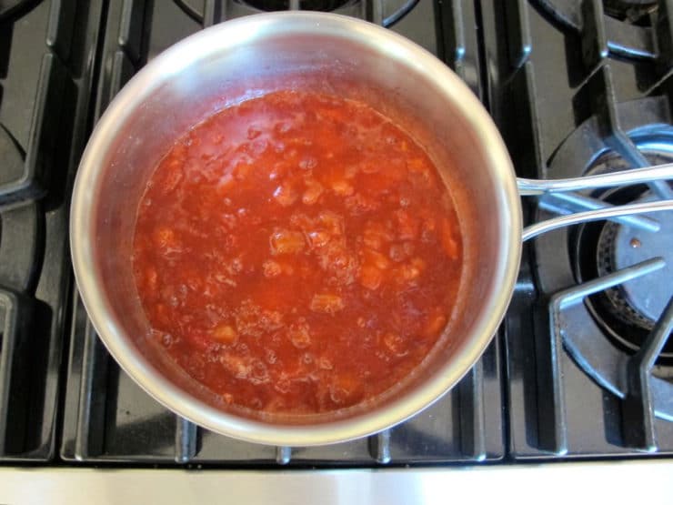 Strawberry rhubarb compote simmering in a saucepan.