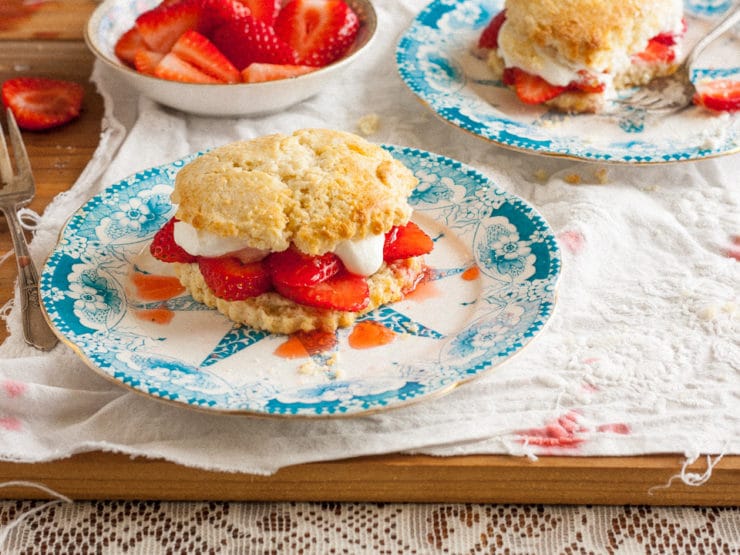 A delectable strawberry shortcake placed on a blue plate, enticingly filled with fresh strawberries and whipped cream