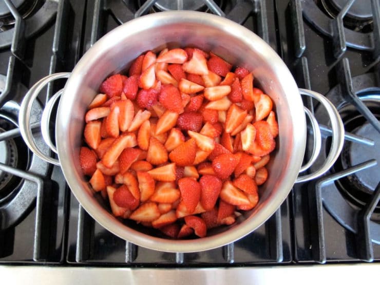 Sliced strawberries in a saucepan.