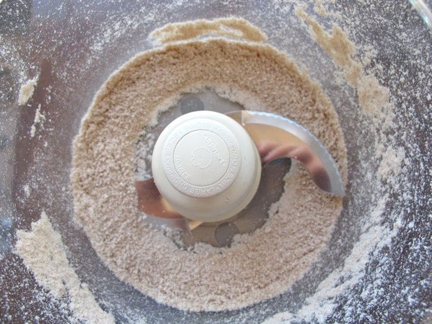 Dried almond meal in a food processor.