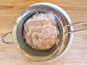 Almond pulp in a strainer.