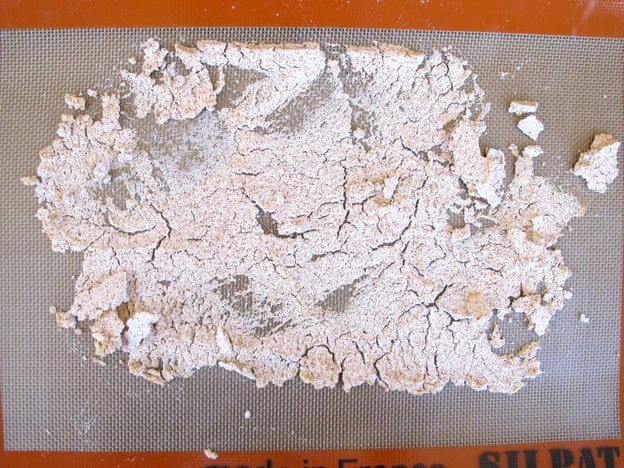 Dried almond meal on a baking sheet.