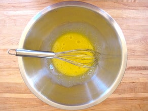 Beaten egg yolks in a mixing bowl.