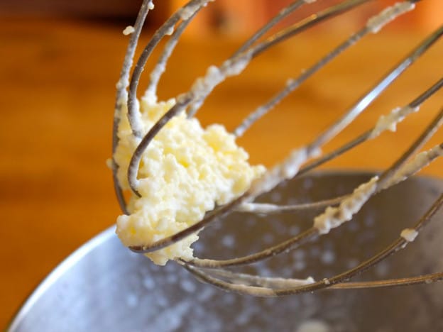 Whipping cream into butter in a stand mixer.