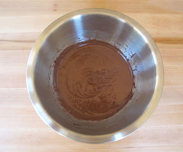 Flour whisked into chocolate cake batter.