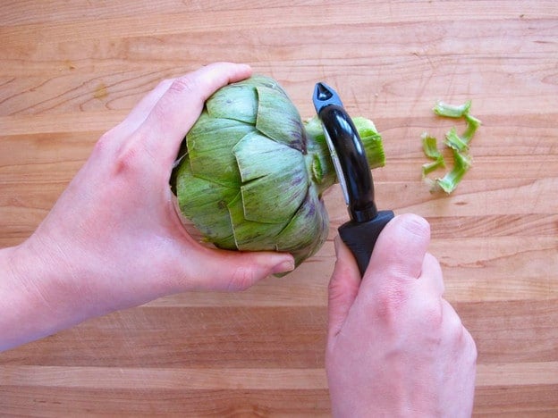 Peeling an artichoke stem.