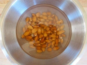 Almonds soaking in a bowl of water.
