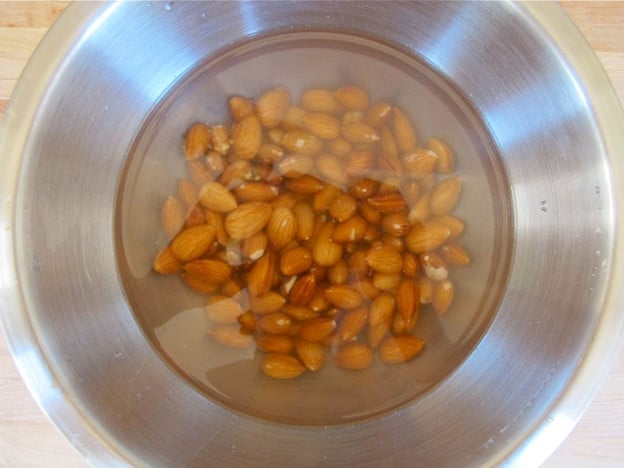 Almonds soaking in a bowl of water.
