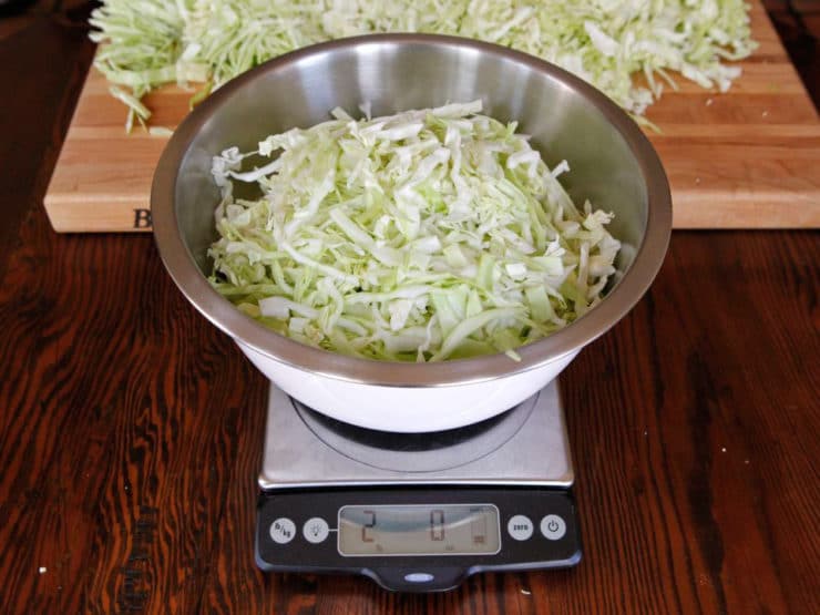Bowl of shredded cabbage on scale.