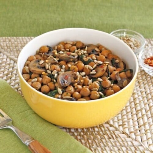 Chickpea, Spinach & Mushroom Sauté - A simple vegan meatless one-pot meal with seared mushrooms, chickpeas, spinach and seasonings, topped with sunflower seeds.