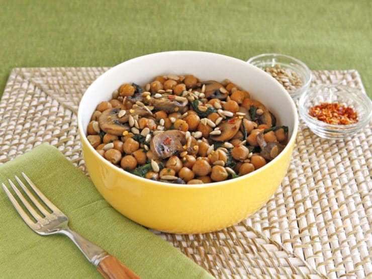 Chickpea, Spinach & Mushroom Sauté - A simple vegan meatless one-pot meal with seared mushrooms, chickpeas, spinach and seasonings, topped with sunflower seeds.