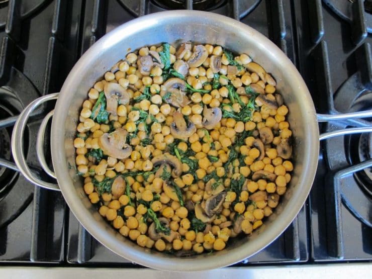 Chickpea, Spinach & Mushroom Sauté - A simple vegan meatless one-pot meal with seared mushrooms, chickpeas, spinach and seasonings, topped with sunflower seeds.