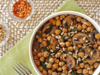 Chickpeas and mushrooms combined in a bowl, part of a delicious Chickpea, Spinach and Mushroom Sauté meal