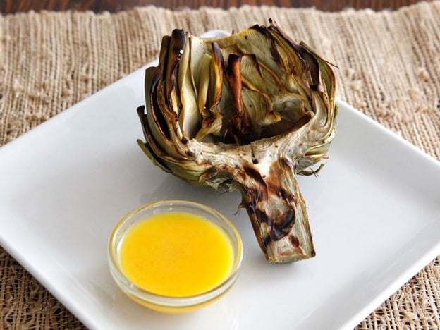 How to Grill Artichokes - Give your artichokes a smoky flavor by finishing them on the grill. Learn how to clean, prep, steam, grill and sauce for tender, smoky results.