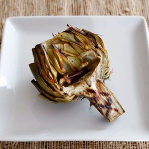 How to Grill Artichokes - Give your artichokes a smoky flavor by finishing them on the grill. Learn how to clean, prep, steam, grill and sauce for tender, smoky results.
