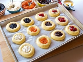 American aFilled kolache on a lined baking sheet.Cakes: Kolache - Learn the history of Czech kolaches, then try a traditional recipe with fillings and posipka from food historian Gil Marks