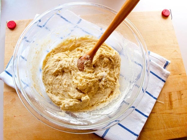 Kneading kolache dough in a mixing bowl.