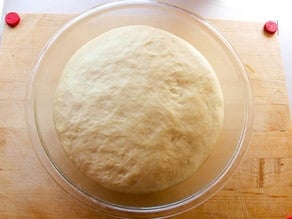 Risen kolache dough in a mixing bowl.