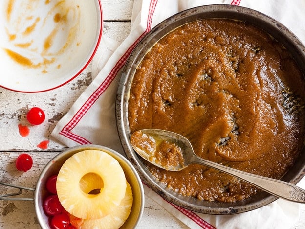 Spreading butter and sugar in an oven-proof skillet.
