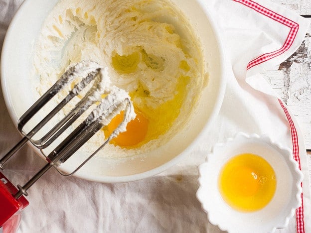 Beating eggs into cake batter.