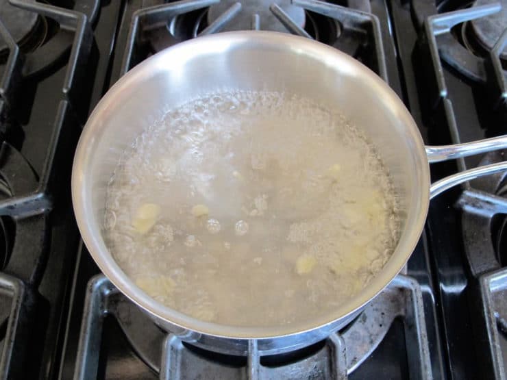 Sliced garlic in boiling water.