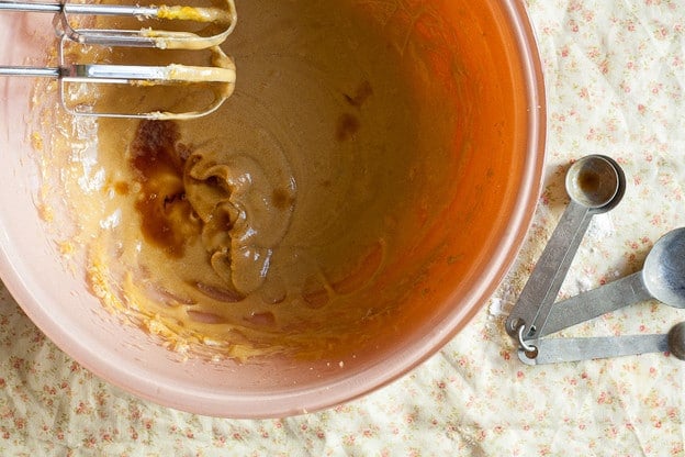 Stirring vanilla into cake batter.